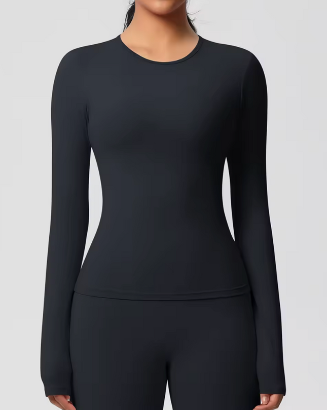 Black long-sleeve  underscrubtop worn by a person on a light gray background